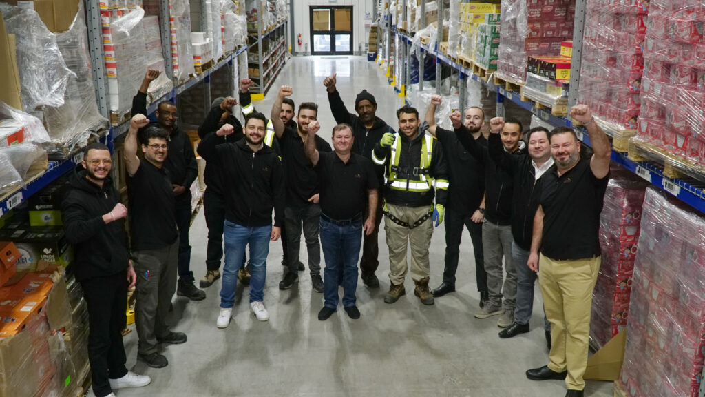 Jenna Foods team with thumbs up sign in the warehouse